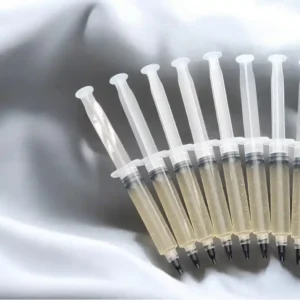 Isolated Syinges laid out on grey cloth to display.
