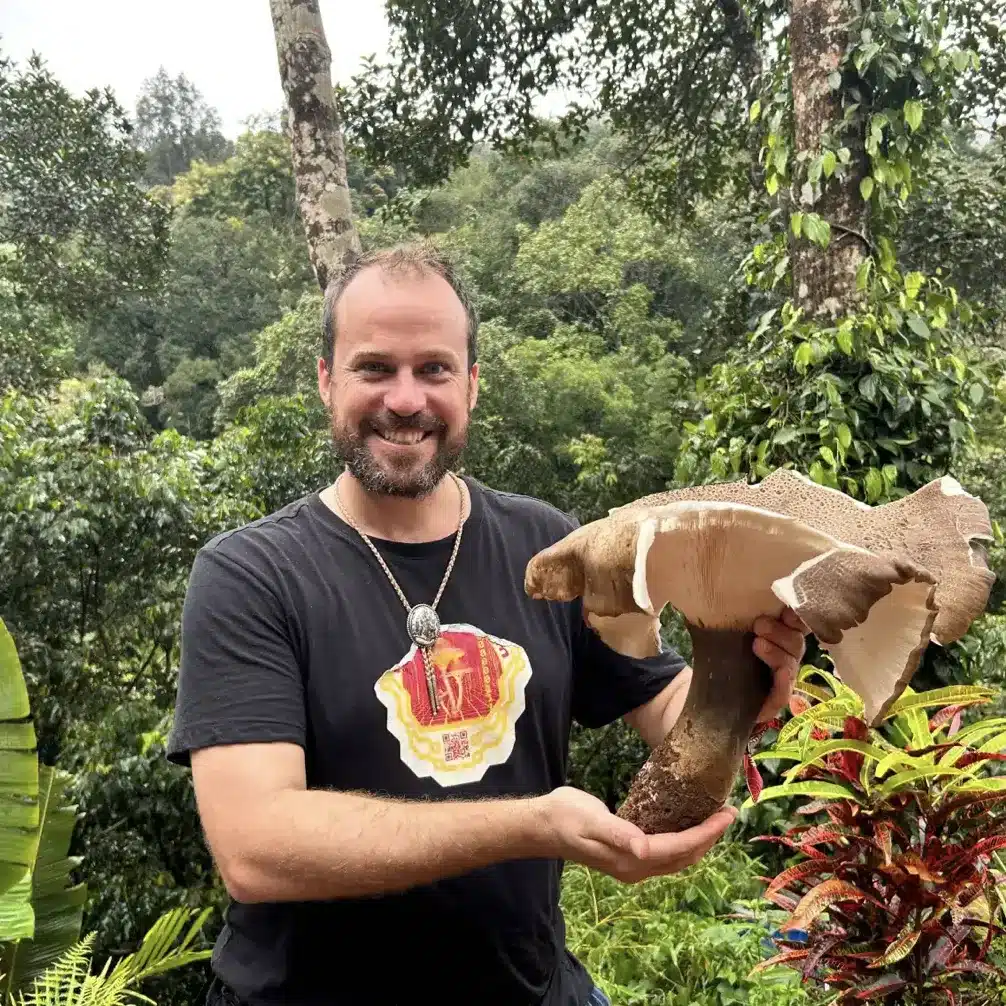Dennis Walker of mycopreneur holding a massive mushroom in central America