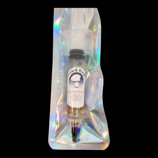 Lizard King Psilocybe cubensis spore syringe prepared for microscopy with visible spore suspension.