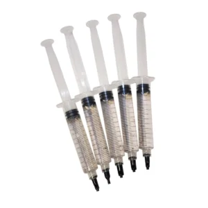 Close-up of spore syringe with visible spore clusters appearing as small black dots.