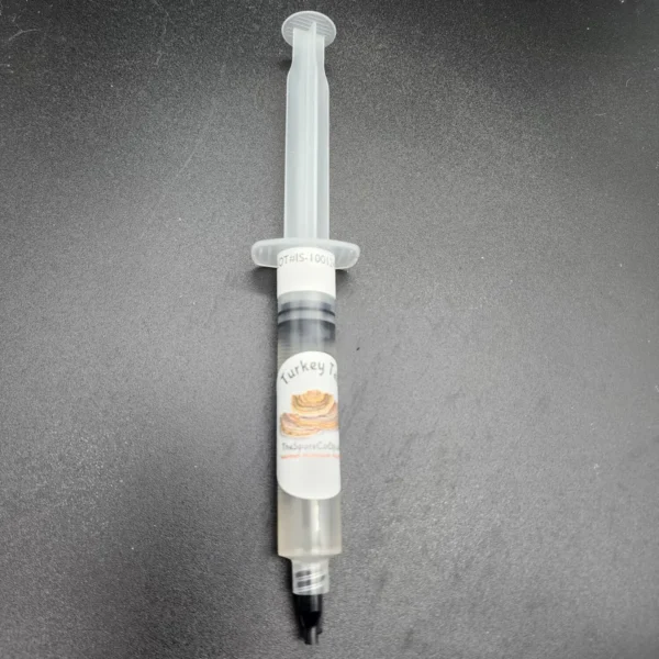 Turkey Tail mushroom liquid culture syringe containing white, fibrous mycelium suspended in nutrient solution.